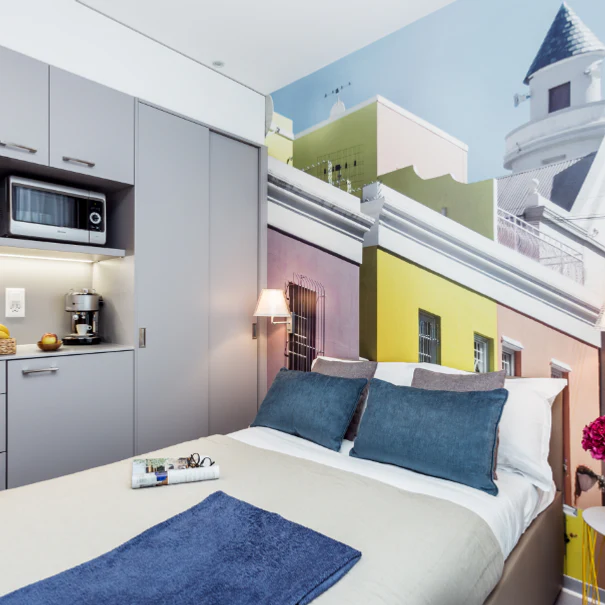 Modern student studio with a kitchenette and a colourful feature wall