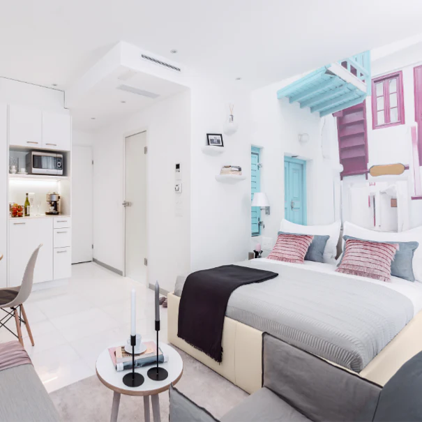 Bright student studio with a kitchenette and living area